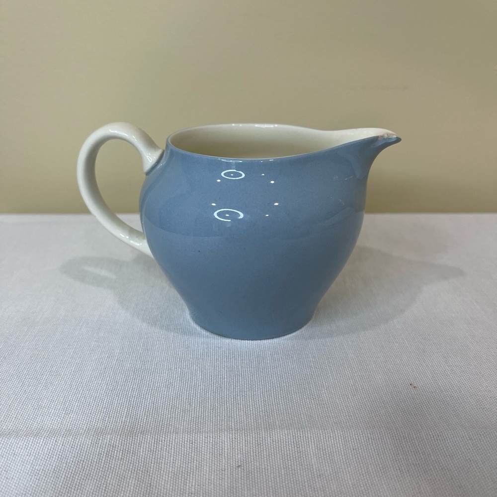 Blue Wedgewood creamer with white handle.
